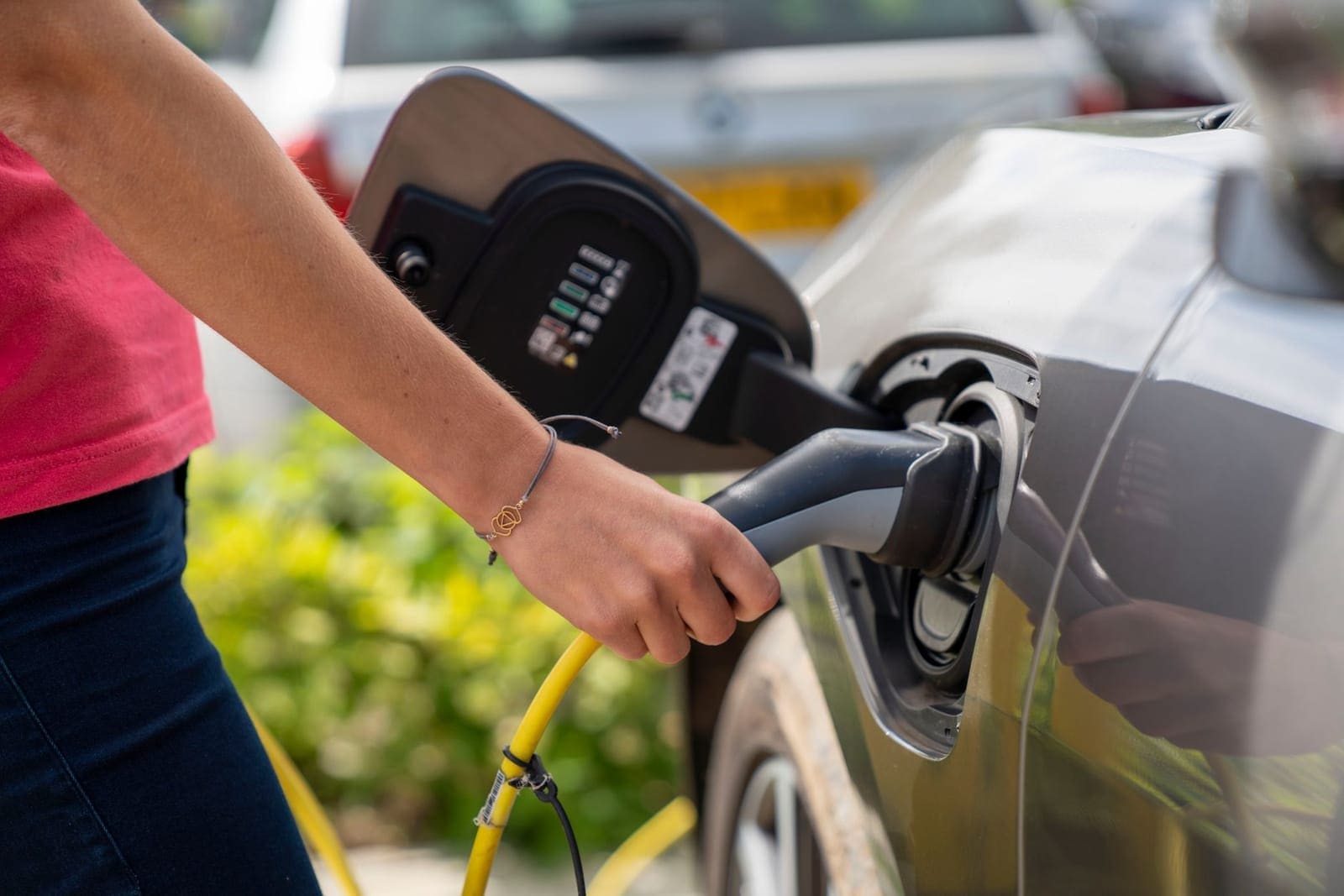 Electric vehicles charging at a row of chargers in a UK commercial car park